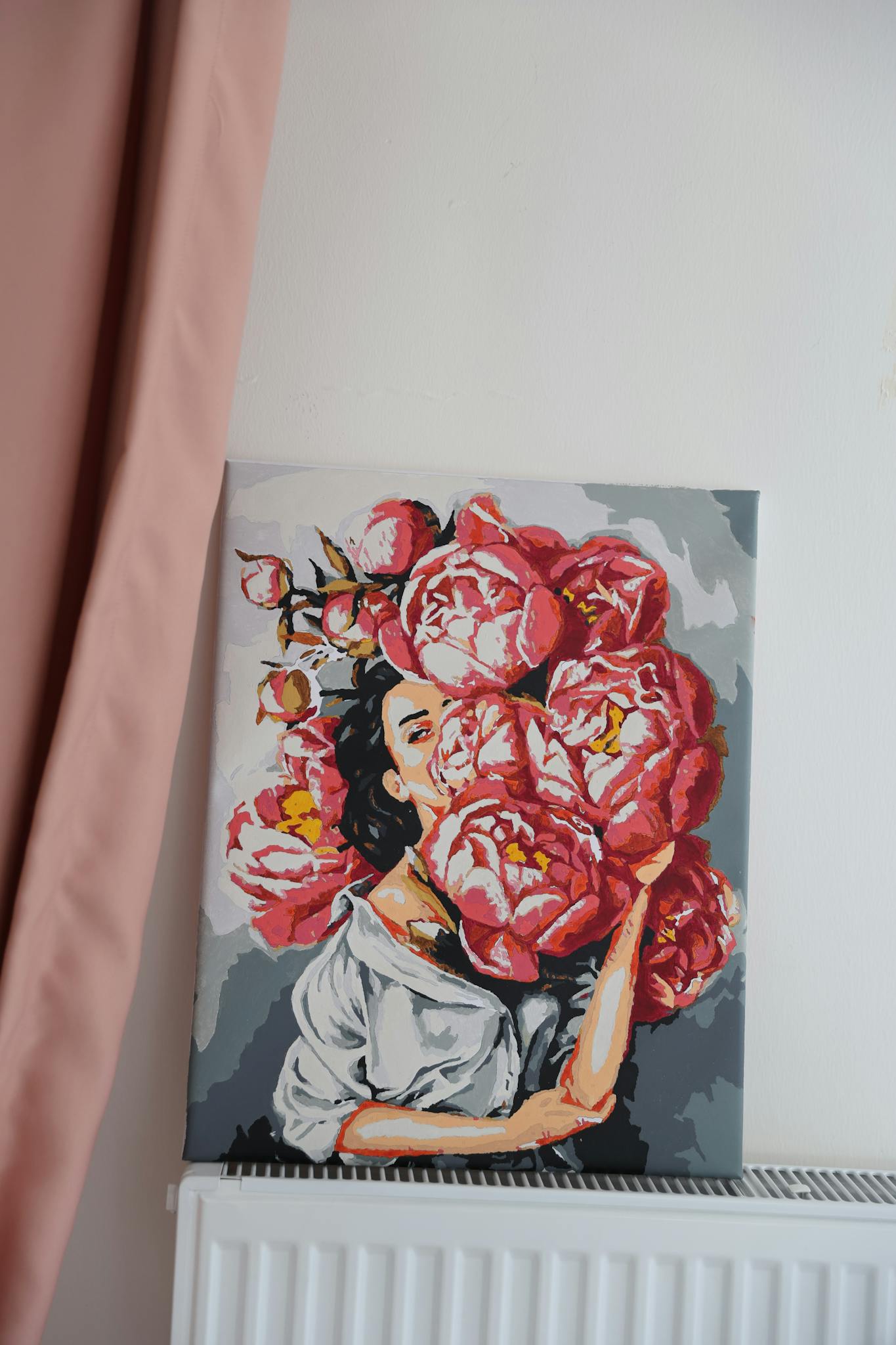 A colorful painting of a woman with floral elements, adding charm to the interior.