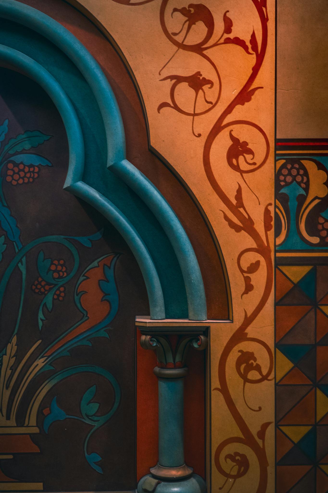Intricate artistic patterns on a colorful architectural wall with rich details.